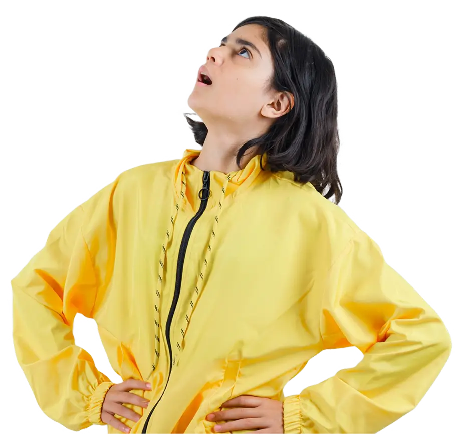 Child in yellow jacket looking upward