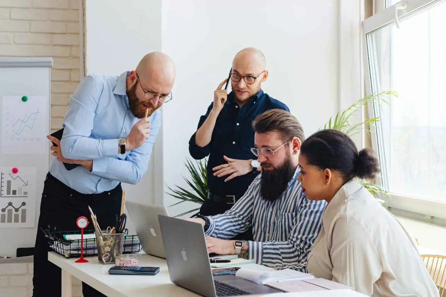 Team collaborating on laptops to improve technical SEO Australia performance.