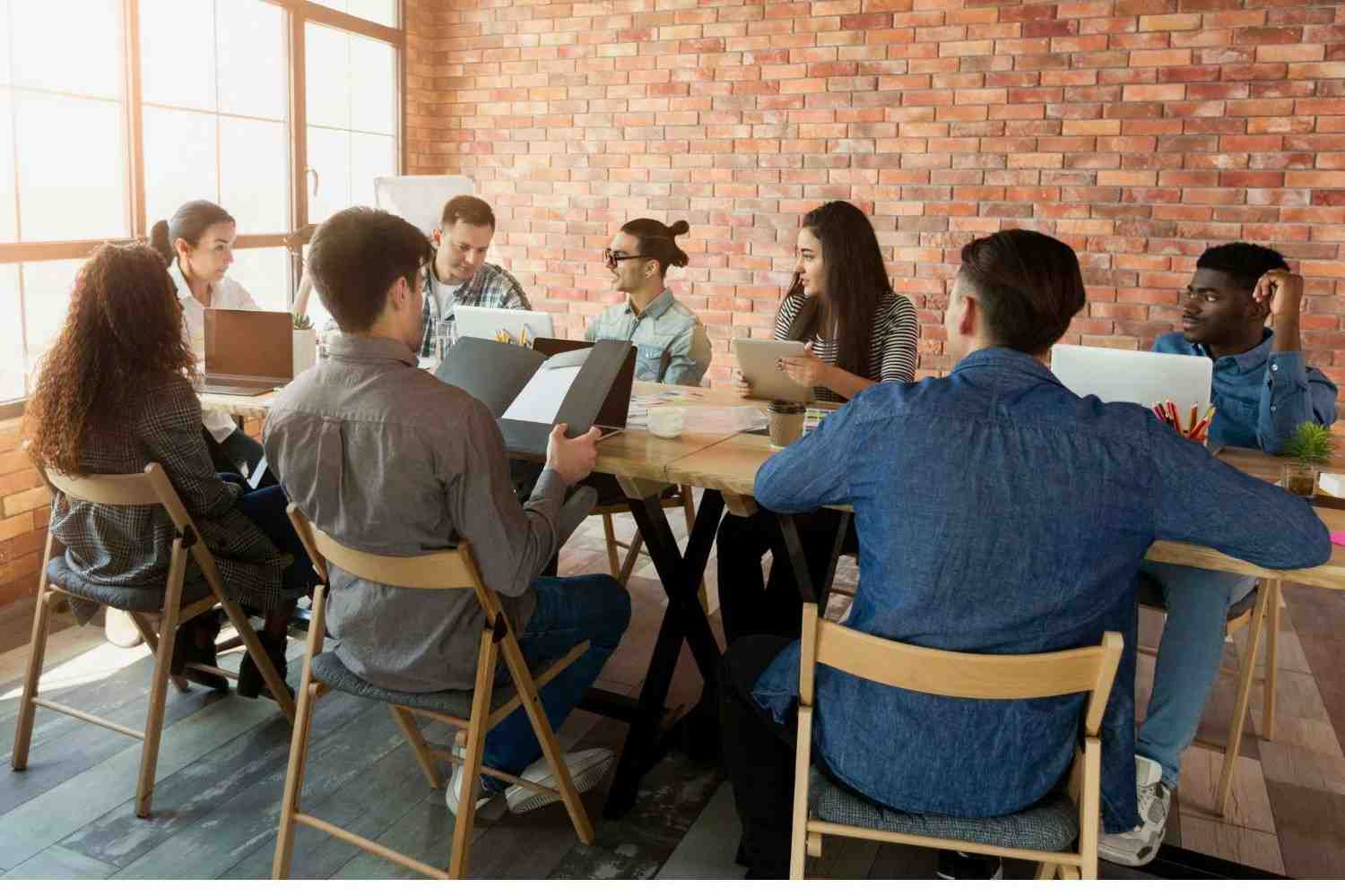 Small business team discussing strategy and data for market research small business in Australia.